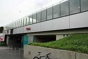 Glassed-in single-story building above roadway