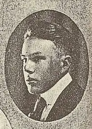 A black-and-white photograph.  Enclosed in an oval, the face of a young man in a suit and tie faces leftward.