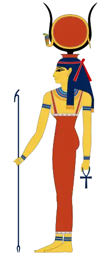 Profile of a woman in ancient Egyptian clothing. She has yellow skin and bears on head a pair of cow horns, between which sits a red disk encircled by a cobra. She holds a forked staff in one hand and an ankh sign in the other.