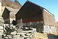 Weather exposed barn walls clad with juniper. Juniper keeps the lashing rain out, permits draft and keeps the hay dry.