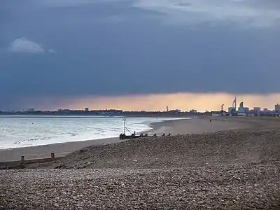 Hayling Island's mainly shingle beach with Portsmouth's Spinnaker Tower beyond