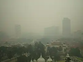 Smog engulfing a city skyline.