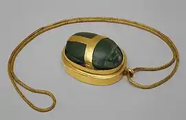 Heart scarab of Hatnefer; 1492–1473 BC; serpentine (the scarab) and gold; 5.3 × 2.8 cm; chain: 77.5 cm; Metropolitan Museum of Art