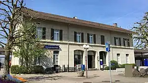 Wide two-story stone building with gabled roof