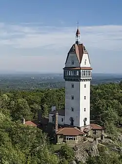 A tower on a forested hill