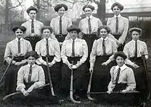 Black and white photographic print showing members, including Hilda M Light, of the Middlesex women's hockey team, 1910/1911.