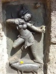 One of the Hirapur yoginis, with an offering of flowers at her feet