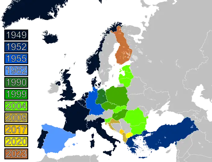 A map of Europe with countries labelled in shades of blue, green, and yellow based on when they joined NATO.