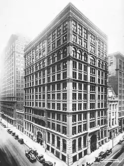 A ten-story square commercial building of various Romanesque designs of its floors, seen at a 3/4 view