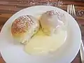 Homemade buchteln served with vanilla sauce