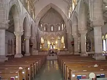 Interior of nave, with fans in pews