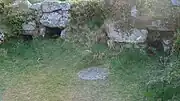 Hound Tor Longhouse open hearth stone and storage niches at inhabited end