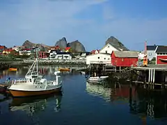 A small fishing boat docked in a small fishing village