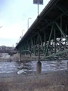 bridge painted green seen from the Mississippi bank