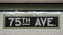 White and green tile mosaic spelling out the station name