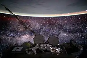 Image 15Outer space from the International Space Station at 400 km (250 mi) altitude in low Earth orbit. In the background the Milky Way's interstellar space is visible, as well as in the foreground, above Earth, the airglow of the ionosphere just below and beyond the so-defined edge of space the Kármán line in the thermosphere (from Outer space)