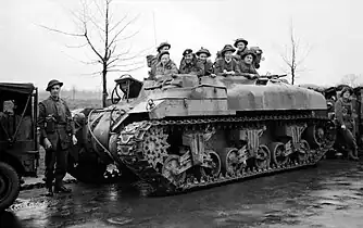 Troops sat in the top of a turretless tank