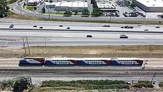 A Freeway next to a Regional Passenger Train