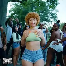 Cover art for "Munch (Feelin' U)": Ice Spice, in denim shorts and a light green tube top, surrounded by a crowd