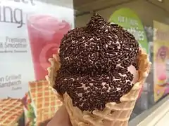 Chocolate soft-serve ice cream with sprinkles in a waffle cone from Dairy Queen