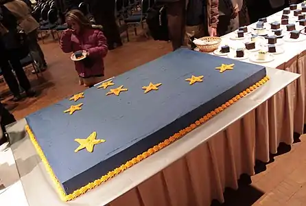 A large sheet cake, served at an inauguration ceremony.