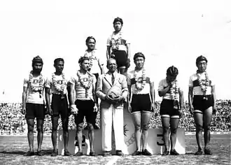 India cyclists at 1951 Asian Games – cycling team pursuit silver medallists Raj Kumar Mehra (standing on podium); Gurdev Singh, Dhangar (Lhanguard), Madan Mohan (standing left to right); and manager Bhoot (standing, fourth from left in blazer)