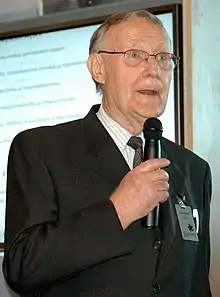 Kamprad holding a microphone