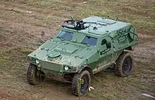 A green unarmed VBL moves in the mud