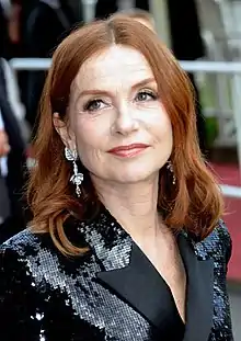 Isabelle Huppert at the 2018 Cannes Film Festival looking to the left and smiling