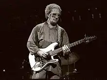 J.J. Cale, playing a guitar