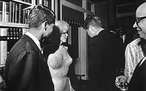 President Kennedy (his back to the camera), U.S. Attorney General Robert Kennedy (left), and actress Marilyn Monroe