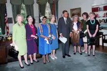 Six women and one man standing in a row in the Oval Office, in 1963.