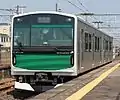 Set V1 running under overhead wires on the Tohoku Line in March 2014