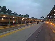 A northward facing view showing the passenger platforms (left) and freight platform (right), as well as the station building.