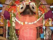 image of a temple idol decorated with flowers and fabric