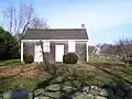 Front view of Friends Meeting House with Jamestown Windmill in background