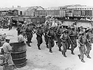 Image 48Gurkhas guide disarmed Japanese soldiers from Bangkok to prisoner of war camps outside the city, September 1945 (from History of Thailand)