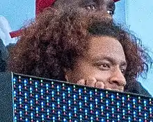 A man peeking above an electronic billboard