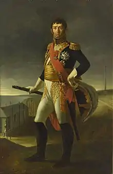 Full-length portrait of a frowning Soult in dark blue marshal's uniform with one hand on his hip and the other holding a spyglass. His breeches are white with black knee boots and he has a gold sash around his waist.