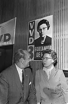 A black and white photograph of a woman and man talking