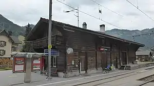 Two-story wooden building with gabled roof