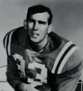 College football player Jim Holder wearing his #33 jersey and posing with a football for a publicity picture