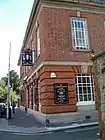 A two-storey brick public house, formerly used as a post office