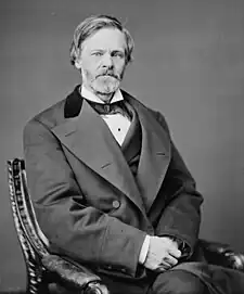 Black-and-white photograph of a man, seated