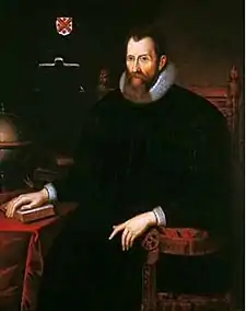 A baroque picture of a sitting man with a beard.