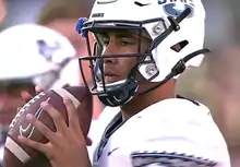 Close up photo of Jordan Love's face, partially obscured by his football helmet