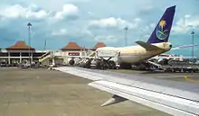 On the apron, Saudi Airlines Boeing 747-300 refueling and reloading to serve Indonesian Hajj pilgrims to Mecca.