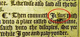 A Bible passage written in a heavy gothic font. The name 'Judas' is partially covered by a piece of paper reading 'Jesus', which is peeling off the page and has been circled in red.