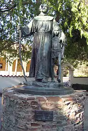 A statue of Saint Father Junípero Serra and a native child at Mission San Fernando