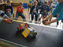  Two students using remote control K*bots in a UK Championship match.